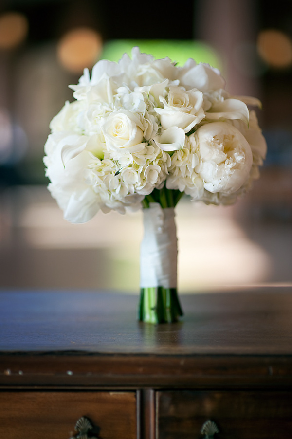 white floral bouquet standing on an antique piece of furniture - photo by Houston based wedding photographer Adam Nyholt